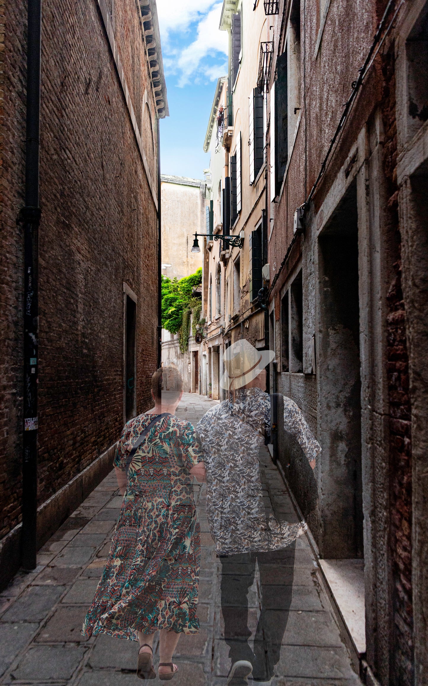 Two people walking down a narrow alleyway between old buildings.